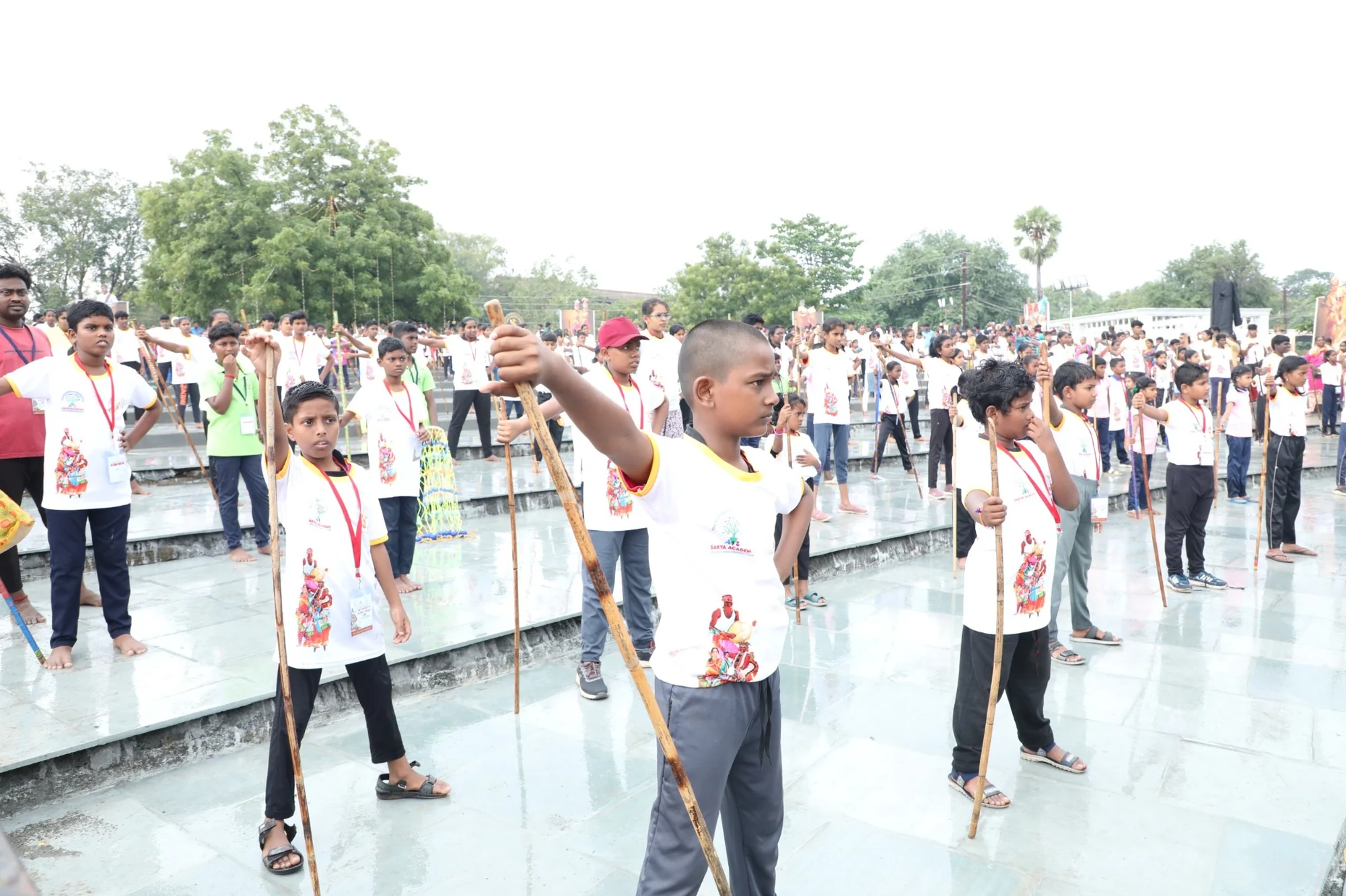 Students practicing Silambam with traditional staffs